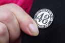 A family member touches her Stardust lapel pin (Brian Lawless/PA)