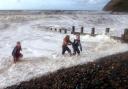 Brothers Dean and Danny Dougherty from Whitehaven  and Loise Gibbs from St Bees are caught by the waves as they run back up the pepples as they play on the beach throwing pepples into the sea at St Bees yesterday (Sun) The sea was coming right up