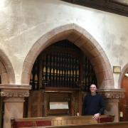 John Corran in front of Nicholson church organ