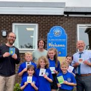 Pupils of St James’ Junior School prepare to send a card to mark “Thinking of You Week” with (l to r) their teacher Neil Carruthers, card designer Jonathan Crosby and head teacher Andrew Beattie