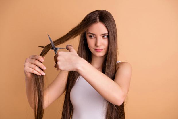A Generic Photo of a woman cutting her own hair.  PA Photo/iStock.