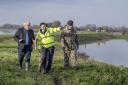 Prime Minister Boris Johnson walks with Lt Col Tom Robinson (right) from the Light Dragoons and Oliver Harmar (centre), the Yorkshire Area Director of the Environment Agency, during a visit to Stainforth, Doncaster, to see the recent flooding. PA Photo.