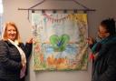 Karen Jones (Left) and June Pearson stand with the tapestry