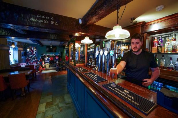A pint in served at this pub over Christmas. Photo via PA.