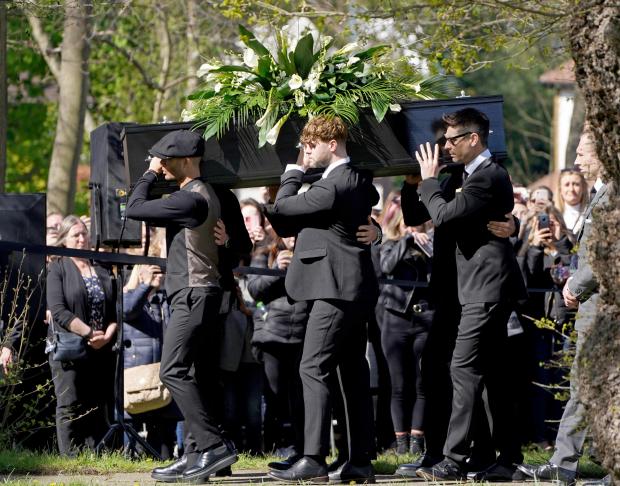 Whitehaven News: Max George (left) and Jay McGuiness of The Wanted (centre) carry the coffin at the funeral of their bandmate Tom Parker. (PA)