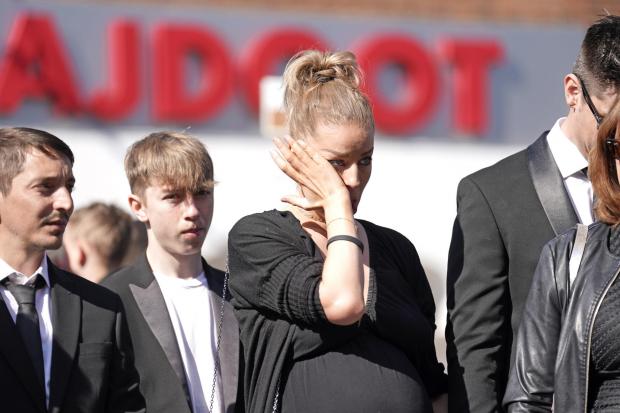 Whitehaven News: Mourners watch as the coffin of The Wanted star Tom Parker is carried ahead of his funeral. (PA)