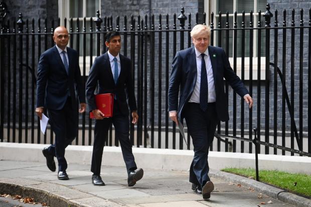 Sajid Javid, Rishi Sunak and Boris Johnson. Credit: PA