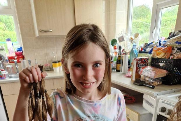 Laila holding the hair she has donated to the Little Princess Foundation