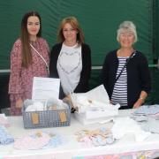 Three generations running the Loved by Lucas baby clothes and gifts stall. Grandmother Rene Chapman, daughter Julie Wilson and granddaughter Beth Wilson.
