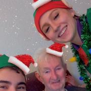 Christmas elves, Jake and Gracebring cheer to one of their clients