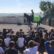 Children's author Helen Haraldsen arrives on horseback to open the new school library