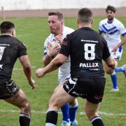 CHARGE: Workington’s Oliver Wilkes 		                Picture: Ben Challis