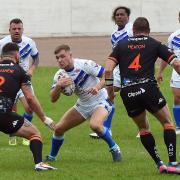JINKING: Town’s Tyler Lancaster looks to burst through the Hunslet defence